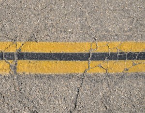 Yellow Road Lines Dividing The Center Of An Old Road